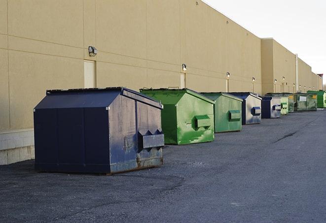 a series of colorful, utilitarian dumpsters deployed in a construction site in Ewing NJ